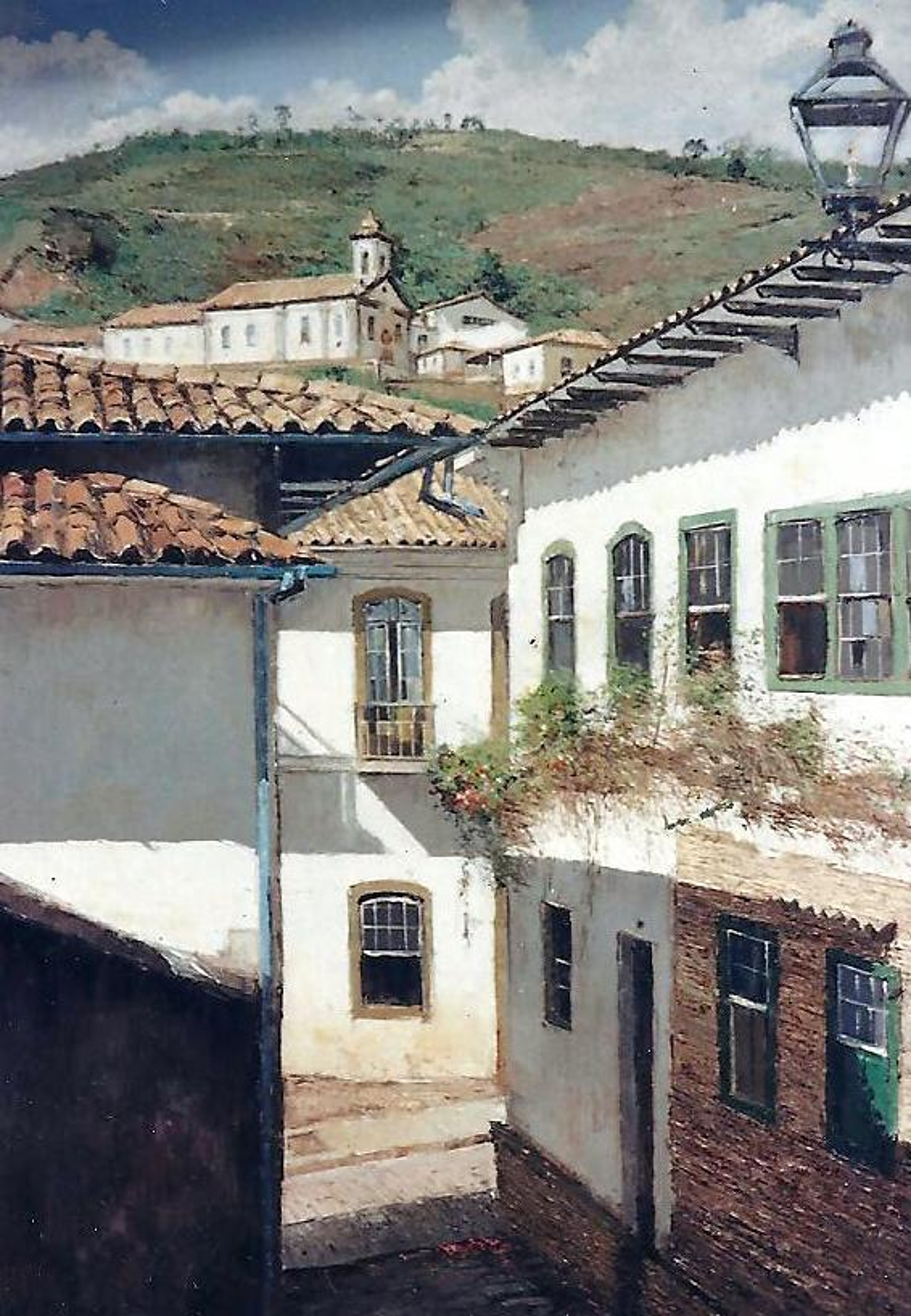 Ouro Preto — Telhados, fachadas e uma igreja compõem a vista entre casas antigas.